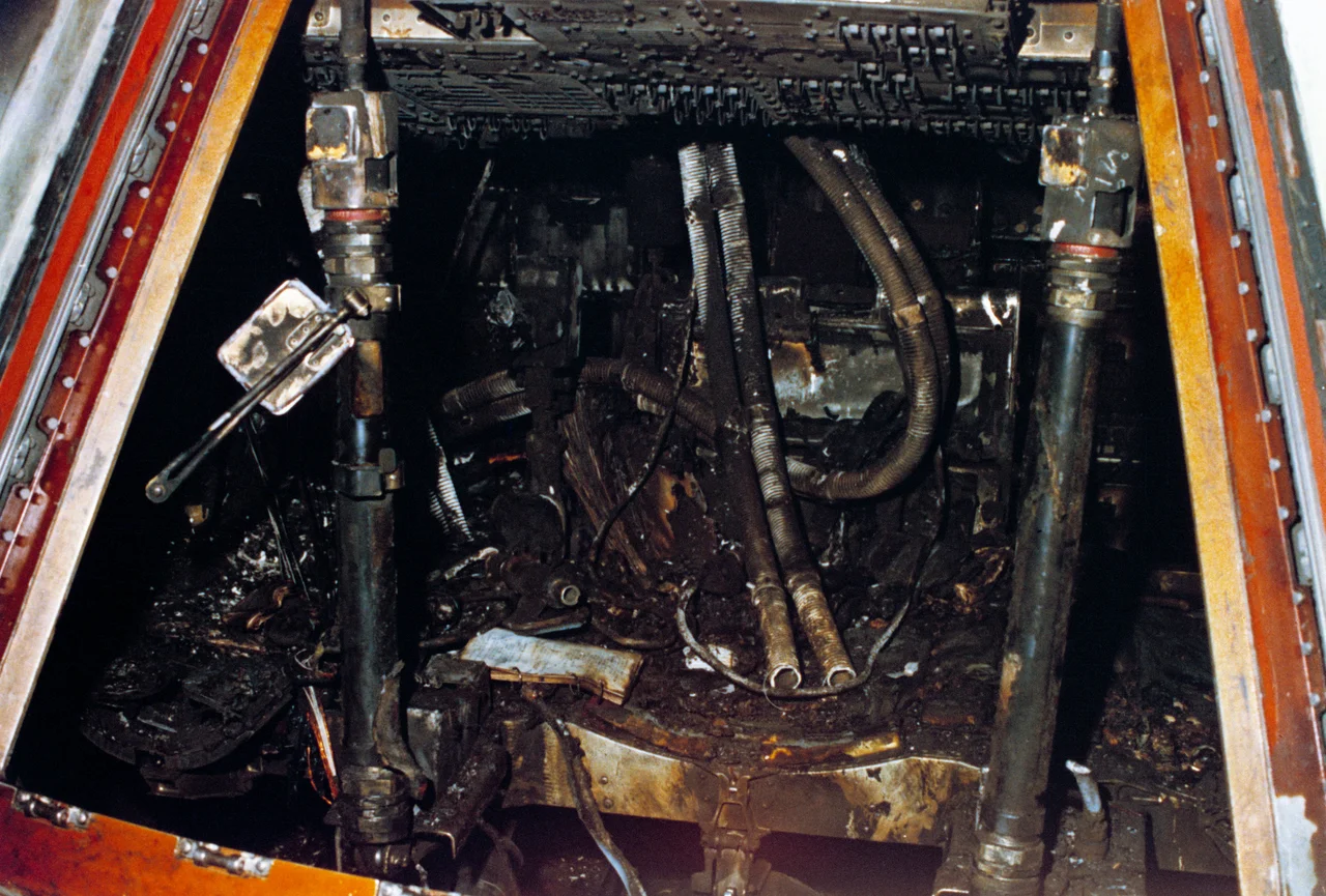 Officially designated Apollo/Saturn 204, but more commonly known as Apollo 1, this close-up view of the interior of the Command Module shows the effects of the intense heat of the flash fire which killed the prime crew during a routine training exercise. 
While strapped into their seats inside the Command Module atop the giant Saturn rocket, a wire bundle that was worn due to misplacement and a sharp-edged access door, sparked and ignited flammable material. This quickly grew into a large fire in the pure oxygen environment. The speed and intensity of the fire quickly exhausted the oxygen supply inside the crew cabin. Unable to deploy the hatch due to its cumbersome design and lack of breathable oxygen, the crew lost consciousness and perished. They were: astronauts Virgil I. "Gus" Grissom, (the second American to fly into space) Edward H. White II, (the first American to "walk" in space) and Roger B. Chaffee, (a "rookie" on his first space mission).