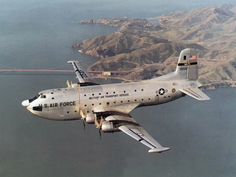 A U.S. Air Force Douglas C-124C Globemaster II (s/n 52-1035) in flight.
Golden Gate Bridge and Marin County, CA in background.
Original caption: "The Douglas C-124C Globemaster II was an airlift workhorse well into the Vietnam War."