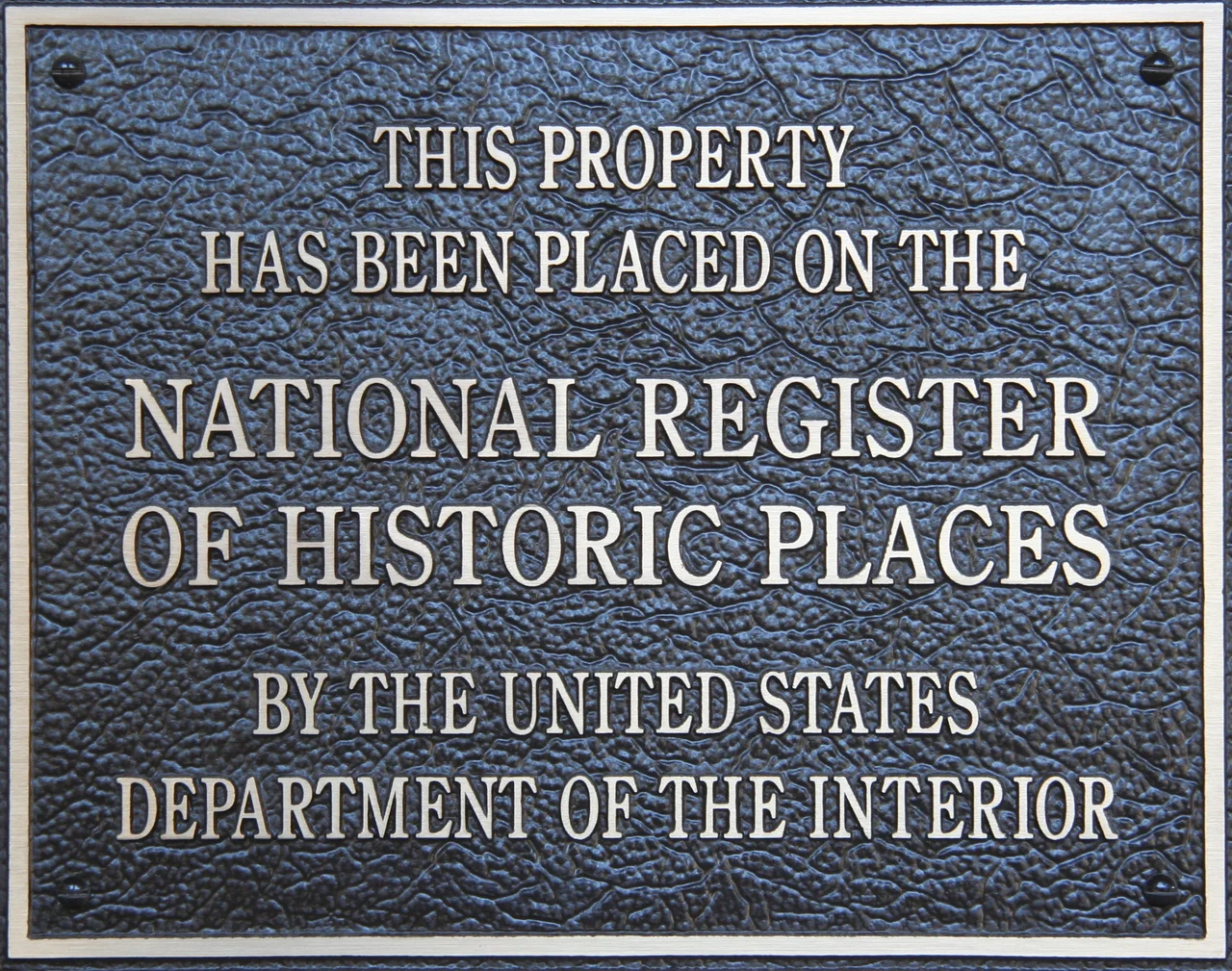 Plymouth Harbor with the Mayflower (behind trees, left), Plymouth Rock (middle) and Cole',s Hill (right)