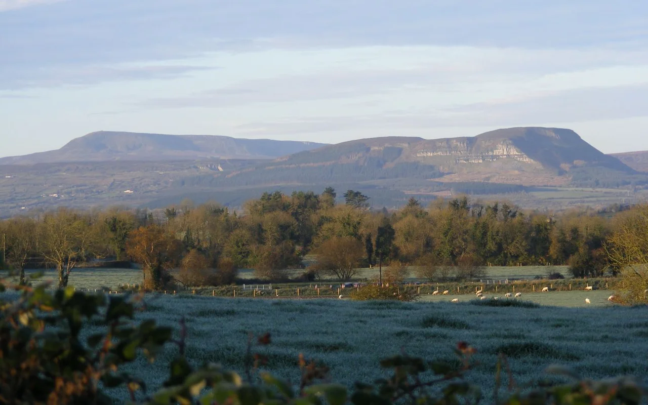 Cuilcagh &amp; Benaughlin mountains in Fermanagh/Cavan, November 2007. Cuilcagh can be seen on the upper left and the cairn is visible. Cuilcagh is roughly twice the height of Benaughlin.